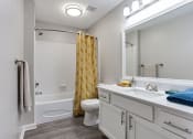 Thumbnail 49 of 49 - a white bathroom with a yellow shower curtain  at Peaks at Gainesville, Gainesville, GA