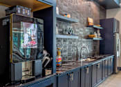 Thumbnail 23 of 36 - A modern kitchen with a refrigerator and a sink.