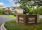 Thumbnail 14 of 20 - A sign for Faris Residences Moncks Corner stands in front of a building.