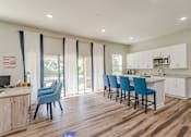 Thumbnail 2 of 20 - a kitchen and living room with a sliding glass door leading to a patio at Summit East Ridge, East Ridge Tennessee