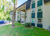 Thumbnail 19 of 20 - a building with green shutters and a blue car parked in front of it at Summit East Ridge, East Ridge