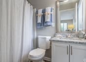 Thumbnail 18 of 31 - a bathroom with a shower and a toilet and a sink