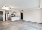 Thumbnail 8 of 29 - Living Area With Kitchen View at The Metro Apartments, Atlanta, 30339