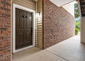 Thumbnail 13 of 20 - A brown door with a glass window is on the left side of the image.