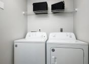 Thumbnail 6 of 14 - a white laundry room with two washes and a dryer