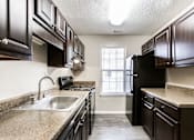 Thumbnail 30 of 60 - Black Appliances in Kitchen at Wildcreek Apartments, Clarkston, GA 30021