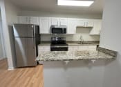 Thumbnail 19 of 31 - Kitchen with microwave at Oasis at Twinwood in Wilmington, NC