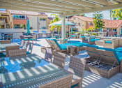 Thumbnail 7 of 18 - a patio with tables and chairs and a swimming pool