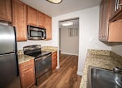 Thumbnail 16 of 18 - a kitchen with stainless steel appliances and granite counter tops