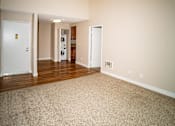 Thumbnail 18 of 18 - an empty living room with wood floors and white walls