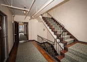 Thumbnail 4 of 13 - A staircase with a metal railing and wooden steps.