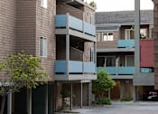Thumbnail 4 of 26 - a view of two buildings with balconies and a courtyard