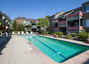 Thumbnail 6 of 26 - a swimming pool in front of an apartment building
