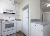 Thumbnail 18 of 26 - a kitchen with white appliances and white cabinets