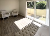 Thumbnail 10 of 15 - a living room with a couch and chairs and a sliding glass door