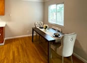 Thumbnail 4 of 22 - a dining room with a table and chairs and a ceiling fan