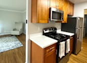 Thumbnail 2 of 22 - a kitchen with stainless steel appliances and wooden cabinets