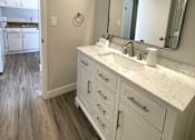 Thumbnail 6 of 15 - an empty bathroom with a sink and a mirror