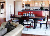 Thumbnail 32 of 39 - Dining room area of an apartment, fitted with wooden flooring, a dining table, and high ceiling.