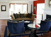 Thumbnail 36 of 39 - Living room area of an apartment, fitted with lounge chairs, a rug and a high ceiling.