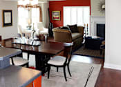 Thumbnail 39 of 39 - Dining and living room area of an apartment fitted with a dining table, wooden flooring, and a high ceiling.