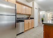 Thumbnail 6 of 39 - Kitchen area of an apartment fitted with high ceiling, spacious cabinets, and tiled flooring at Park Lane Villa.