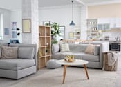 Thumbnail 1 of 2 - a living room and kitchen with couches and a coffee table