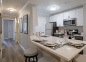 Thumbnail 7 of 15 - a kitchen with a large island with a breakfast bar