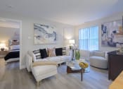 Thumbnail 2 of 8 - a living room with white furniture and a glass coffee table