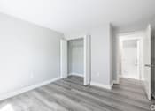 Thumbnail 21 of 30 - A room with a white door and a grey floor.