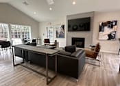 Thumbnail 16 of 16 - A modern living room with a fireplace and a television.