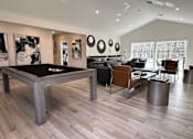 Thumbnail 10 of 16 - A billiard table is in the middle of a room with a black cloth on it.