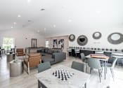 Thumbnail 3 of 30 - A modern living room with a checkered table in the middle.