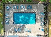 Thumbnail 26 of 30 - An aerial view of a swimming pool surrounded by lounge chairs.