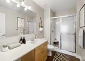 Thumbnail 17 of 19 - A bathroom with a white countertop and a white toilet.