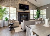 Thumbnail 3 of 19 - A modern living room with a fireplace and a flat screen TV mounted above it.