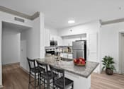 Thumbnail 2 of 30 - white kitchen with island and barstools and stainless steel appliances at The Aster Sugar Land, Sugar Land, TX