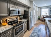 Thumbnail 6 of 30 - Fully Equipped Kitchen at The Aster Sugar Land Apartments, Sugar Land, Texas