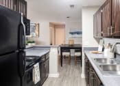Thumbnail 3 of 40 - Galley Kitchen leading to Dining Room located at Addison on Cobblestone located in Fayetteville, GA 30215