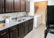Thumbnail 2 of 40 - Kitchen with in unit laundry located at Addison on Cobblestone located in Fayetteville, GA 30215