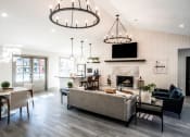 Thumbnail 29 of 40 - clubhouse lounge with couches and chairs and a fireplace at Addison on Cobblestone, Fayetteville, GA