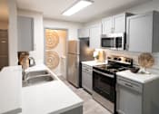 Thumbnail 1 of 22 - Kitchen with Stainless Steel Appliances at The Addison at Collierville Apartments, Collierville
