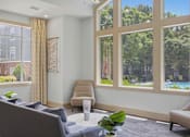 Thumbnail 23 of 42 - Bright lounge area with large windows and comfortable seating at Alden Place at South Square Apartments, Durham, 27707