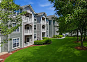 Thumbnail 41 of 42 - Three story apartment buildings with balconies and landscaping at Alden Place at South Square Apartments, Durham, NC