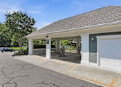 Thumbnail 38 of 42 - Covered carport with electric vehicle charging station at Alden Place at South Square Apartments, Durham, NC