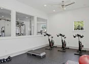 Thumbnail 22 of 42 - Fitness room with spin bikes and workout equipment at Alden Place at South Square Apartments, Durham, NC
