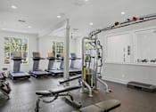 Thumbnail 20 of 42 - Fitness center with treadmills and cable machine at Alden Place at South Square Apartments, Durham, North Carolina