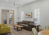 Thumbnail 37 of 42 - Clubhouse lounge with french doors and comfortable seating at Alden Place at South Square Apartments, North Carolina, 27707