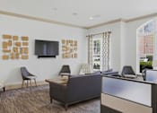 Thumbnail 34 of 42 - Clubhouse lounge with television and contemporary furniture at Alden Place at South Square Apartments, Durham, NC 27707