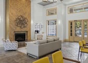 Thumbnail 19 of 42 - Clubhouse lobby with fireplace and high ceilings at Alden Place at South Square Apartments, Durham